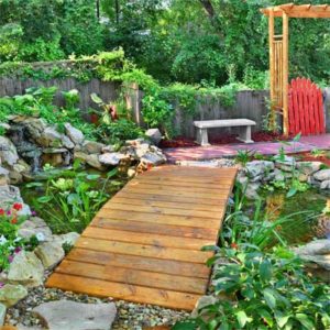 Bridge over Calm Koi Pond. Great design for entertaining and displaying beautiful garden fish. (Photo courtesy of thisoldhouse.com)